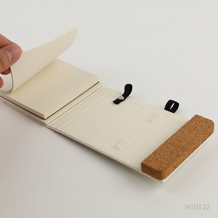 Libreta portacelular hecha en buena medida con envases de leche reciclados. También, tiene un detalle en corcho. 