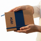 Cuaderno dover de color azul con logo personalizado. Regalo empresarial.